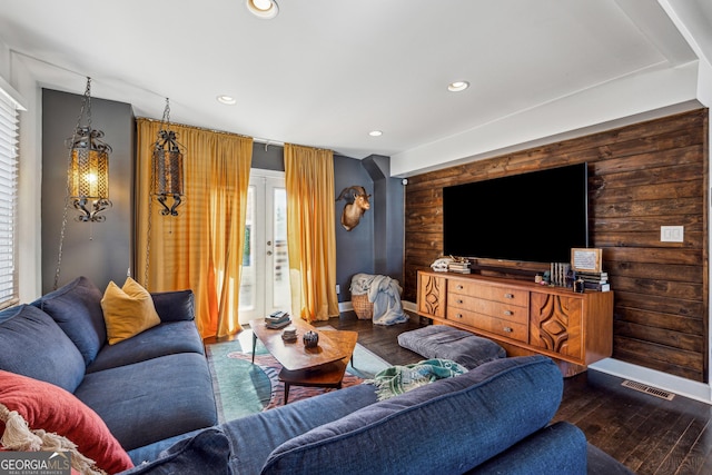 living area with wooden walls, wood finished floors, and recessed lighting