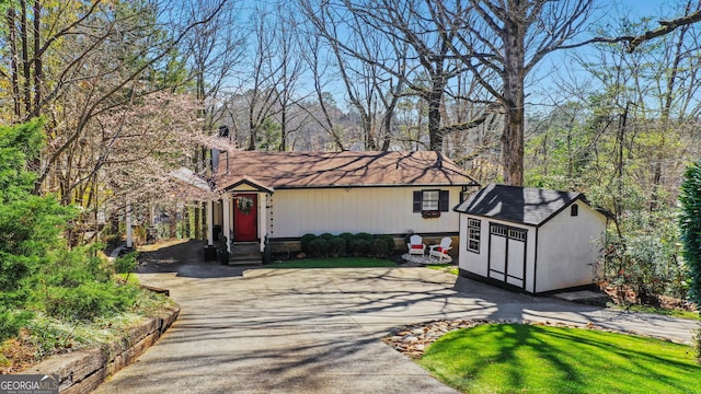 view of front of home featuring a storage shed and an outdoor structure