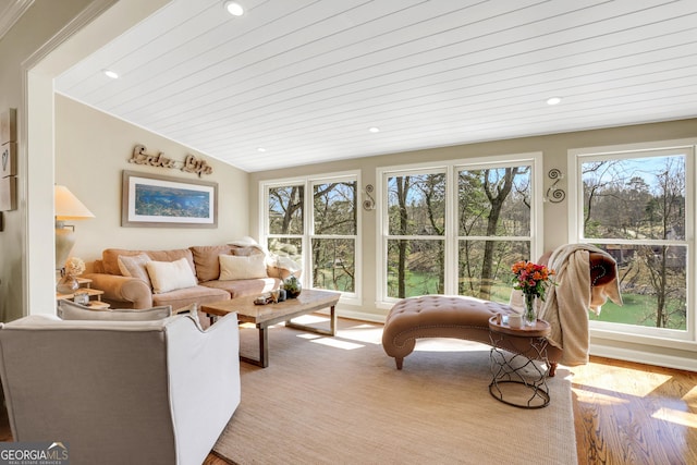 living area featuring recessed lighting, lofted ceiling, and wood finished floors