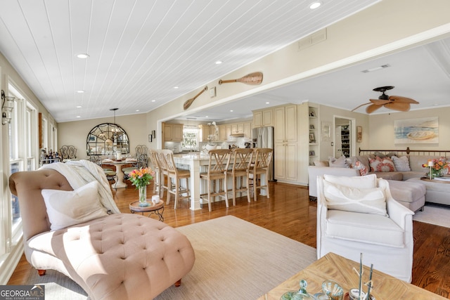 living room with wood ceiling, recessed lighting, visible vents, and light wood finished floors