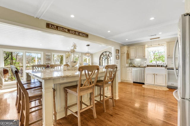 dining space with crown molding, recessed lighting, visible vents, and light wood finished floors