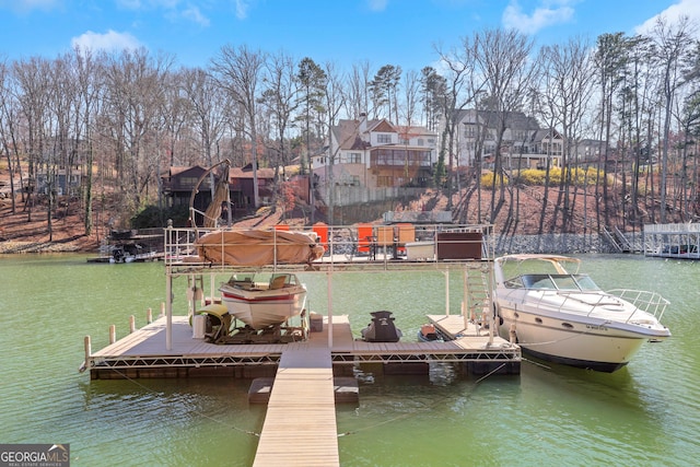 dock area with a residential view and a water view