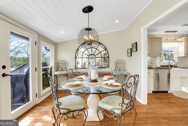 dining area with recessed lighting, an inviting chandelier, light wood finished floors, baseboards, and wood ceiling