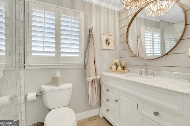 full bathroom with a healthy amount of sunlight, toilet, vanity, and ornamental molding