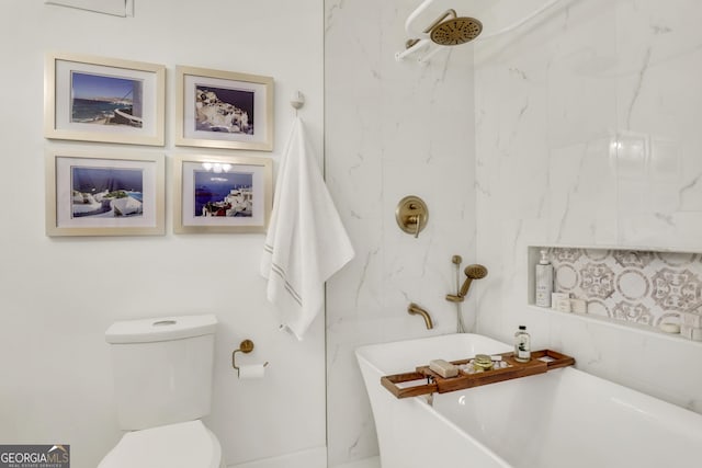 full bath featuring a freestanding tub and toilet