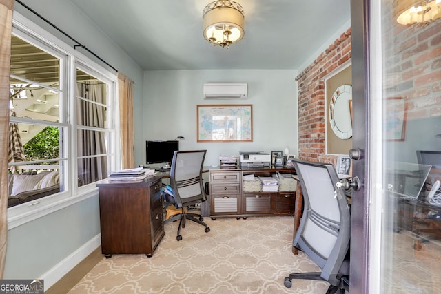 home office with baseboards, an AC wall unit, and brick wall