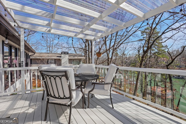 deck with outdoor dining area and a pergola