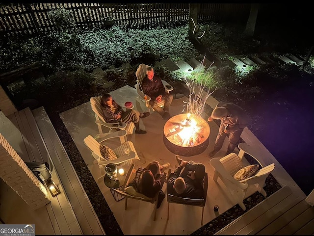 details with fence and an outdoor fire pit