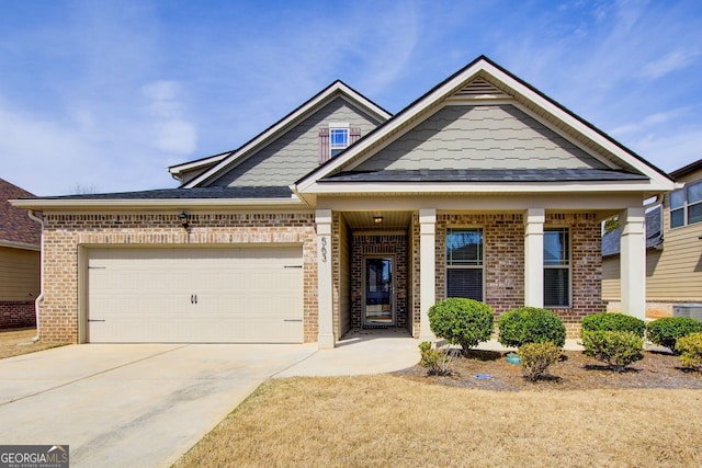 view of front facade featuring brick siding, concrete driveway, and an attached garage