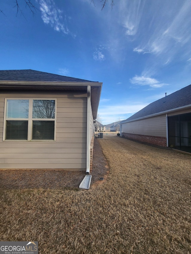 view of home's exterior with a yard