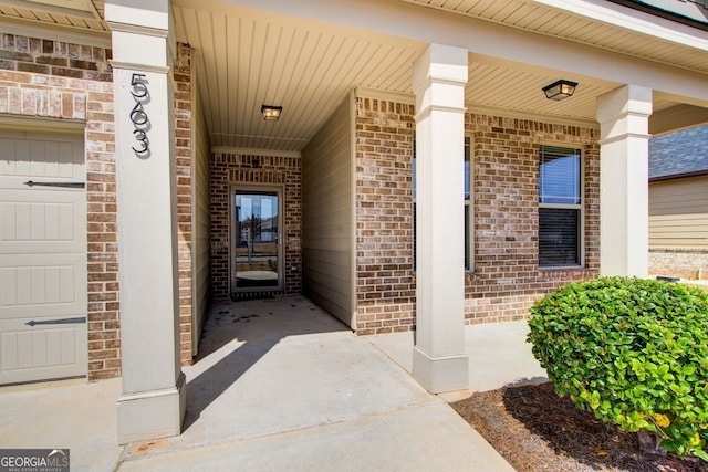 entrance to property featuring brick siding