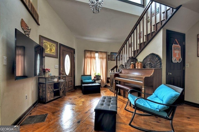 interior space featuring baseboards, visible vents, hardwood / wood-style floors, and stairs