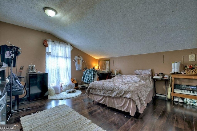 bedroom featuring a textured ceiling, vaulted ceiling, and wood finished floors