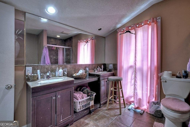 full bathroom with toilet, a stall shower, vaulted ceiling, and a sink