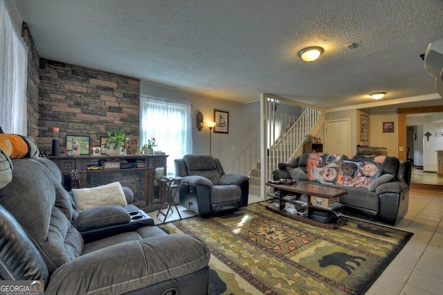 living area with stairs, ornamental molding, a textured ceiling, and tile patterned floors