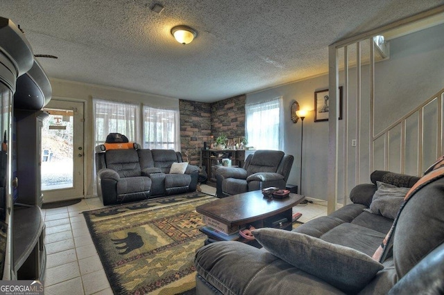 living room featuring light tile patterned floors and a textured ceiling