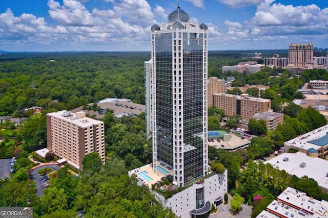 birds eye view of property featuring a view of trees