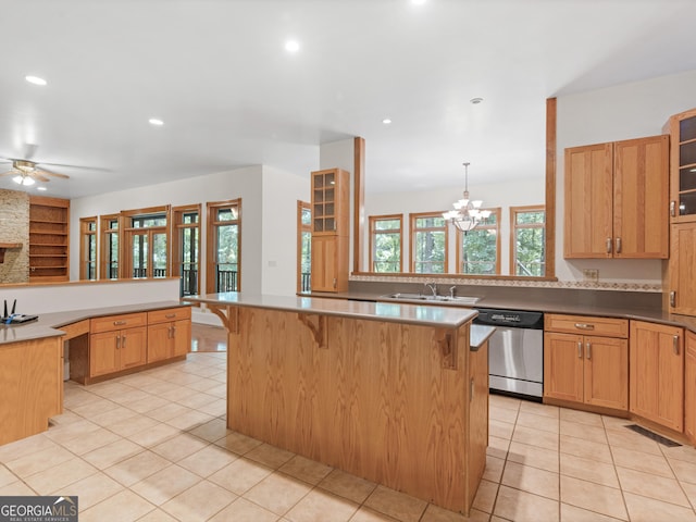 kitchen featuring dishwasher, a breakfast bar area, a sink, and visible vents