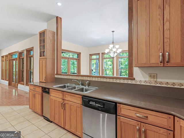 kitchen featuring dishwasher, light tile patterned floors, plenty of natural light, and a sink