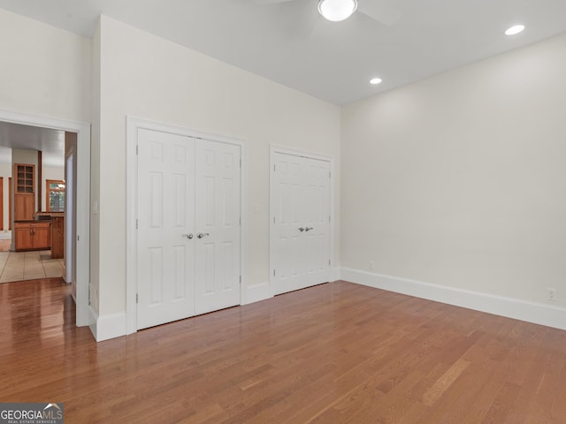 unfurnished bedroom with baseboards and wood finished floors