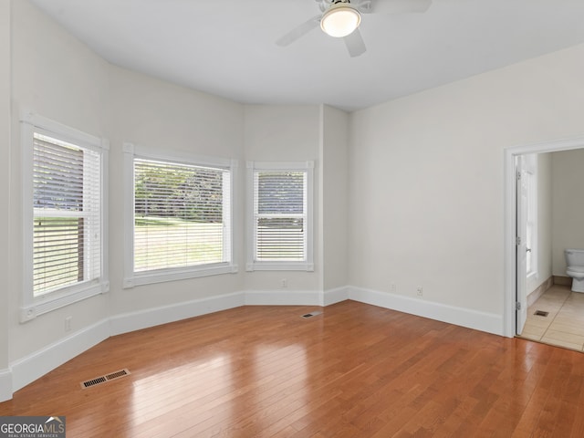 interior space featuring wood-type flooring, visible vents, and baseboards