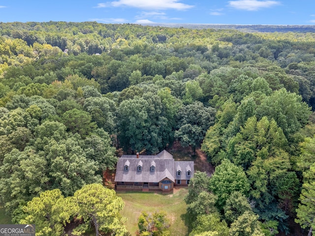 birds eye view of property with a wooded view