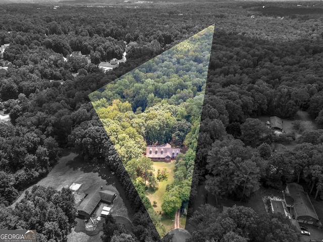 drone / aerial view featuring a forest view