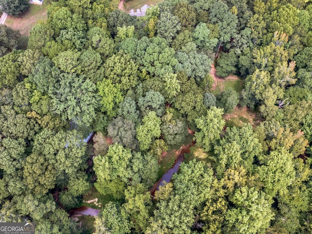 birds eye view of property featuring a view of trees