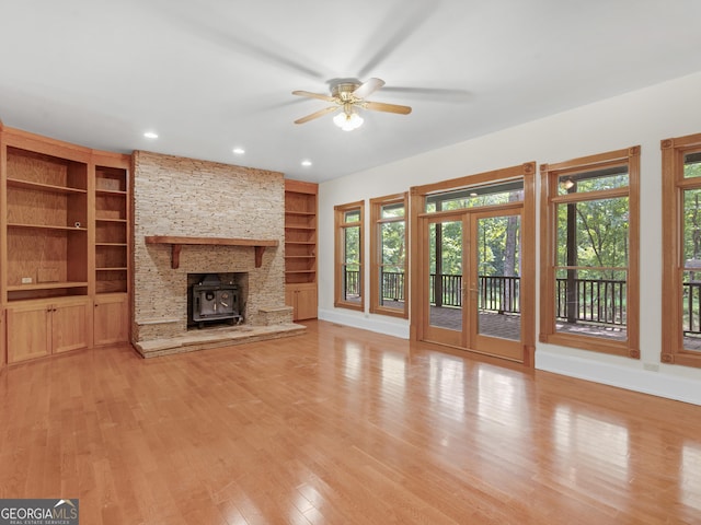 unfurnished living room featuring french doors, light wood-type flooring, a ceiling fan, and baseboards