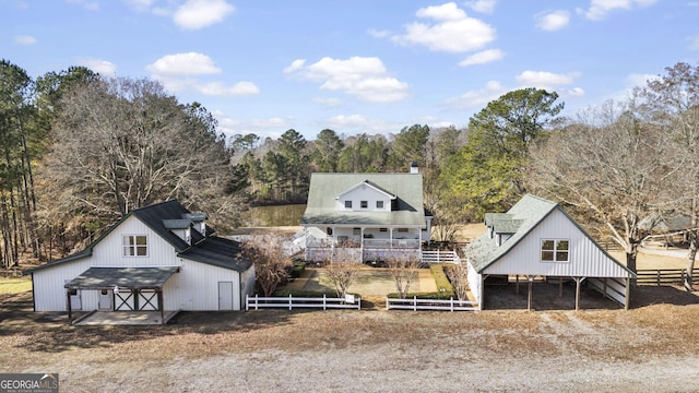 rear view of house with an outbuilding, an outdoor structure, a barn, and fence