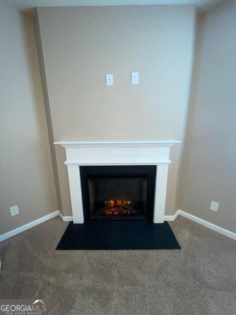 details with a fireplace with flush hearth, carpet flooring, and baseboards