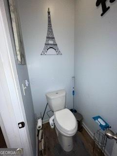 bathroom with toilet and wood finished floors