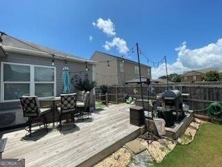 wooden terrace featuring fence