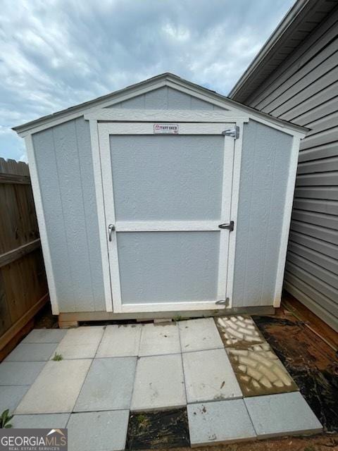 view of shed with fence