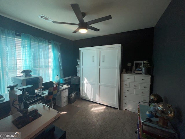 office with carpet floors, ceiling fan, and visible vents