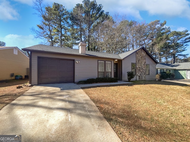 mid-century home featuring an attached garage, a chimney, a front lawn, and concrete driveway