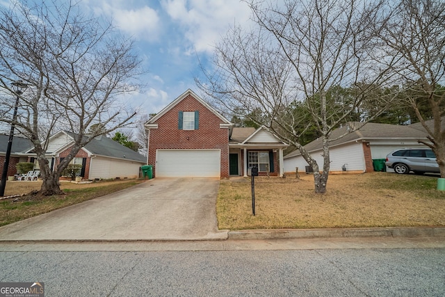 traditional-style house with a garage, a front yard, concrete driveway, and brick siding