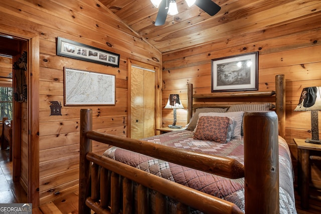 bedroom featuring wooden walls, wood ceiling, and lofted ceiling