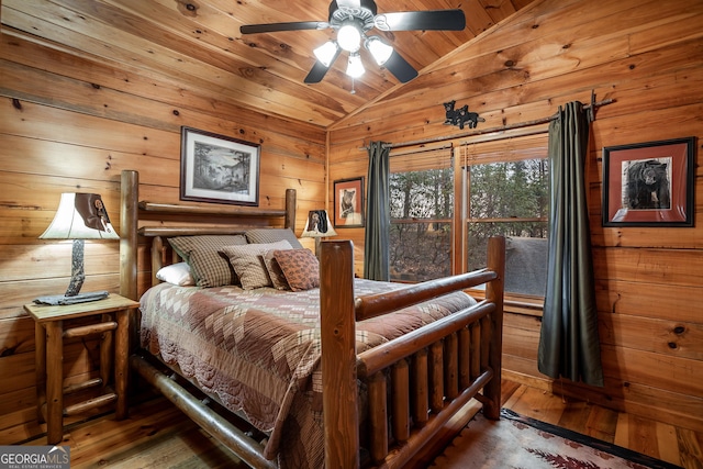 bedroom with wood walls, wood ceiling, lofted ceiling, and wood finished floors