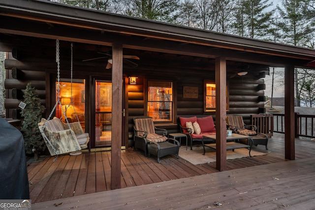 wooden terrace with an outdoor hangout area