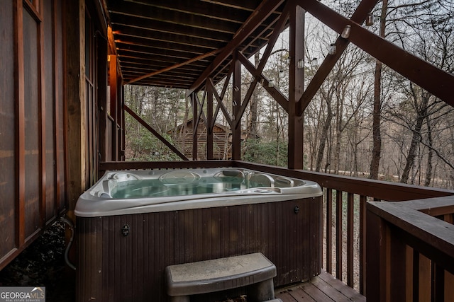 wooden deck featuring central air condition unit and a hot tub