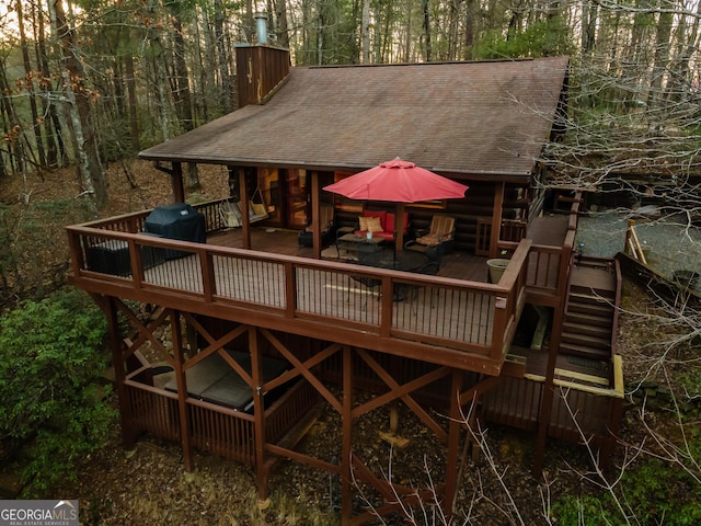 exterior space with a grill and a wooded view