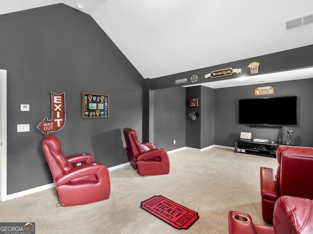 home theater room with carpet floors, baseboards, visible vents, and lofted ceiling