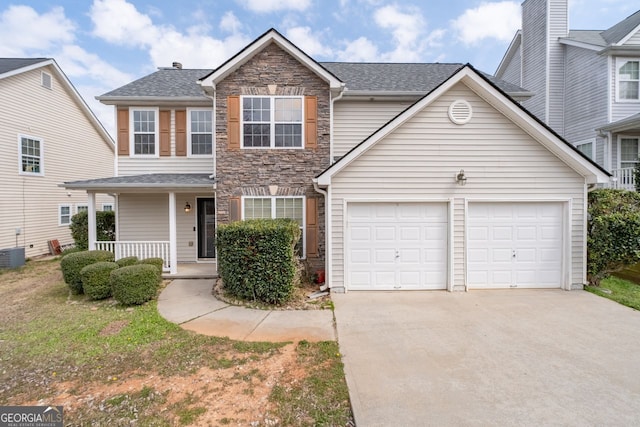 view of front of house featuring a porch, stone siding, an attached garage, and concrete driveway