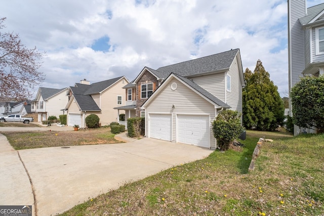 traditional-style home with a shingled roof, concrete driveway, an attached garage, a residential view, and a front lawn