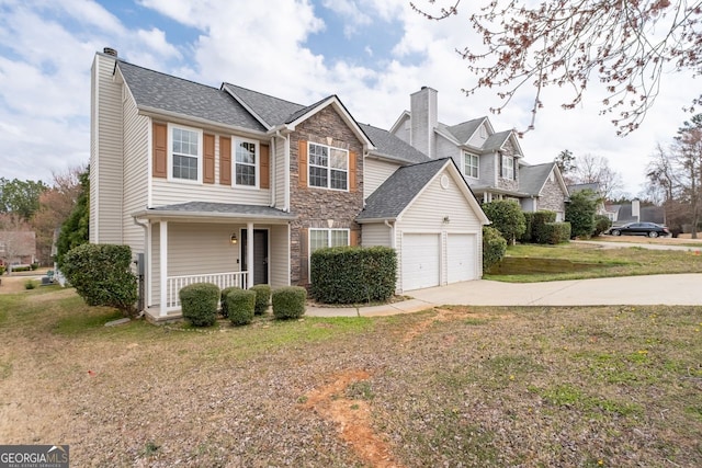 traditional-style house featuring a porch, driveway, stone siding, a chimney, and a front yard