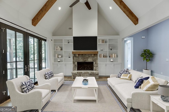 living area with high vaulted ceiling, built in shelves, a fireplace, visible vents, and beam ceiling