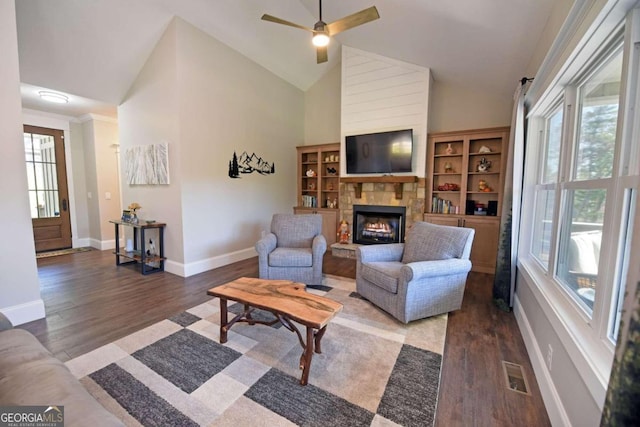 living room featuring high vaulted ceiling, a fireplace, wood finished floors, visible vents, and baseboards