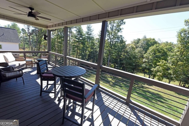 wooden terrace featuring ceiling fan and outdoor lounge area