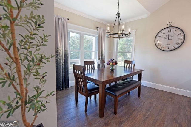 dining room with dark wood-type flooring, a chandelier, crown molding, and baseboards